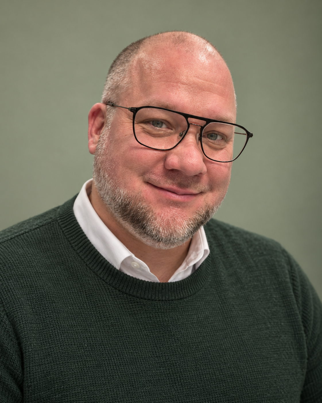 Andreas Parment wearing glasses and a dark green sweater